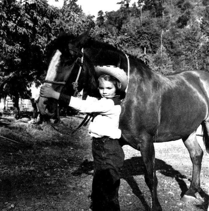 young cowgirl with horse