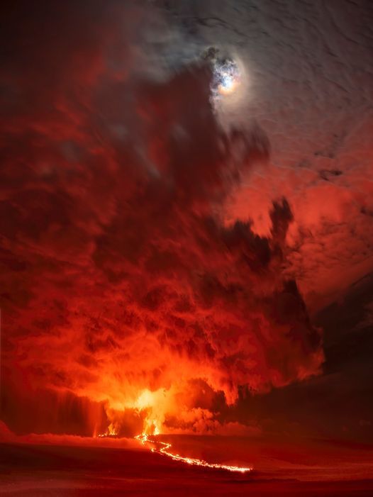 The moon above Mauna Loa erupting