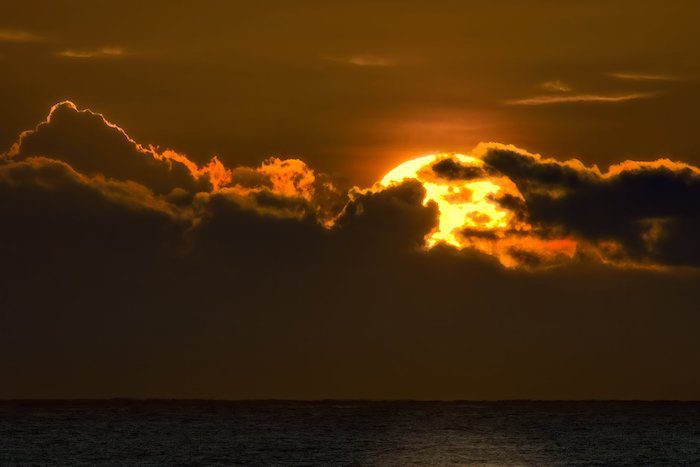 Closeup view of the sunset between the clouds