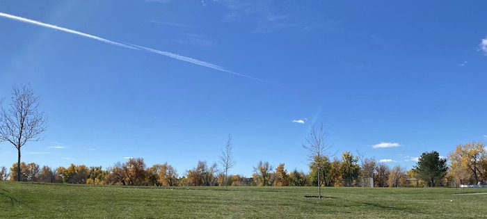 Long view of the sky, tress, and the field