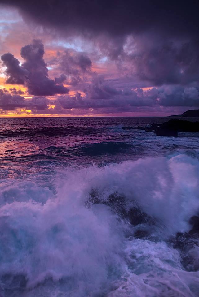 A stormy sky over the ocean with waves crashing.