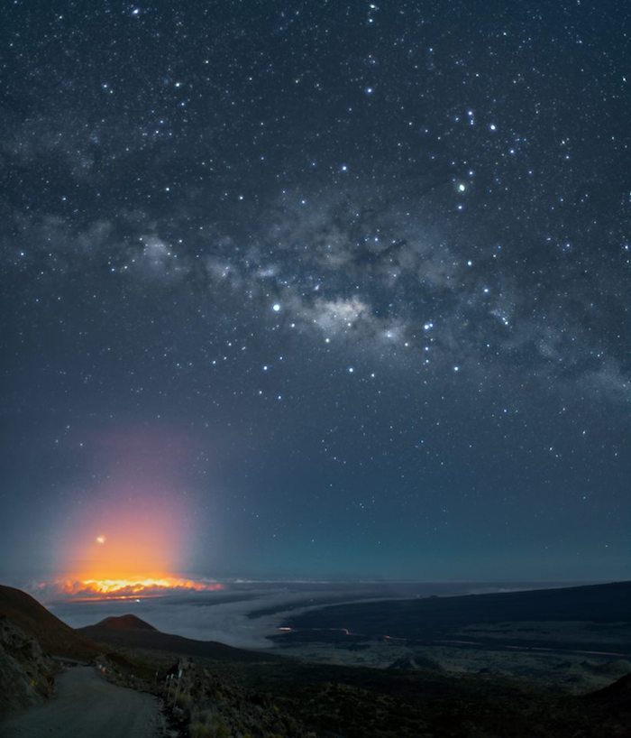 The milky way over a mountain in the night sky.