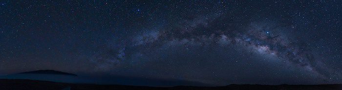 The milky in the night sky above a mountain.