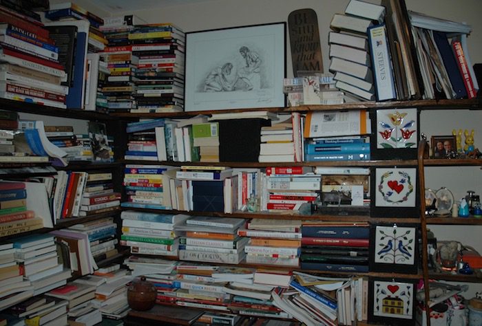 A room with a lot of books on a shelf.