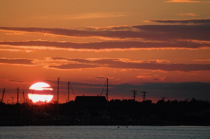 The sun is setting over a body of water.