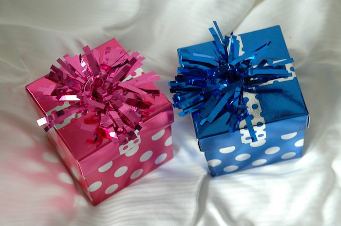 Two pink and blue gift boxes with polka dot ribbons.