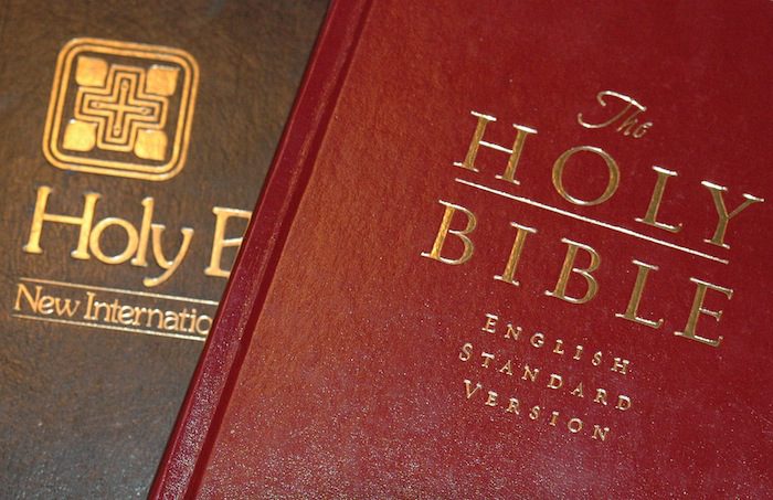 Two bibles with the word holy on them.