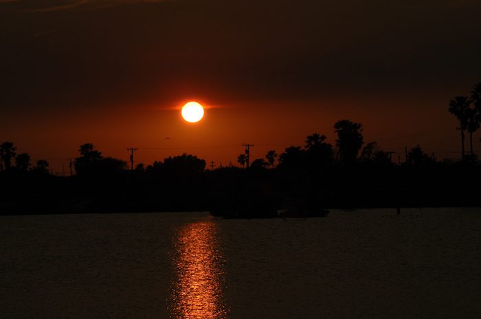 The sun is setting over a body of water.