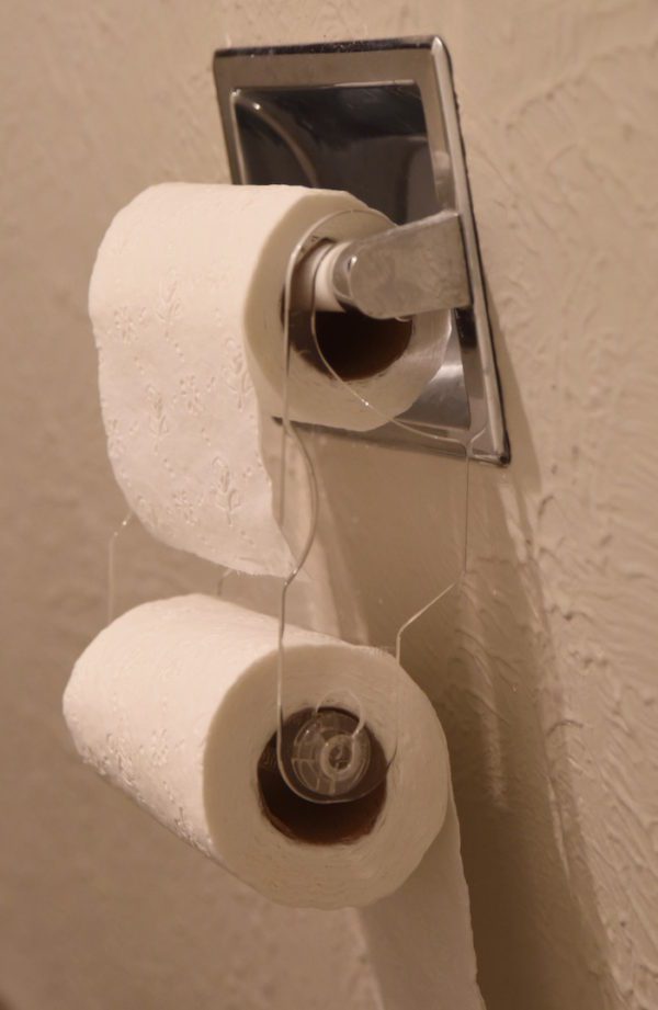 A toilet paper holder with two rolls of toilet paper.