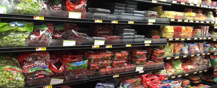 Fruits and vegetables on shelves in a grocery store.